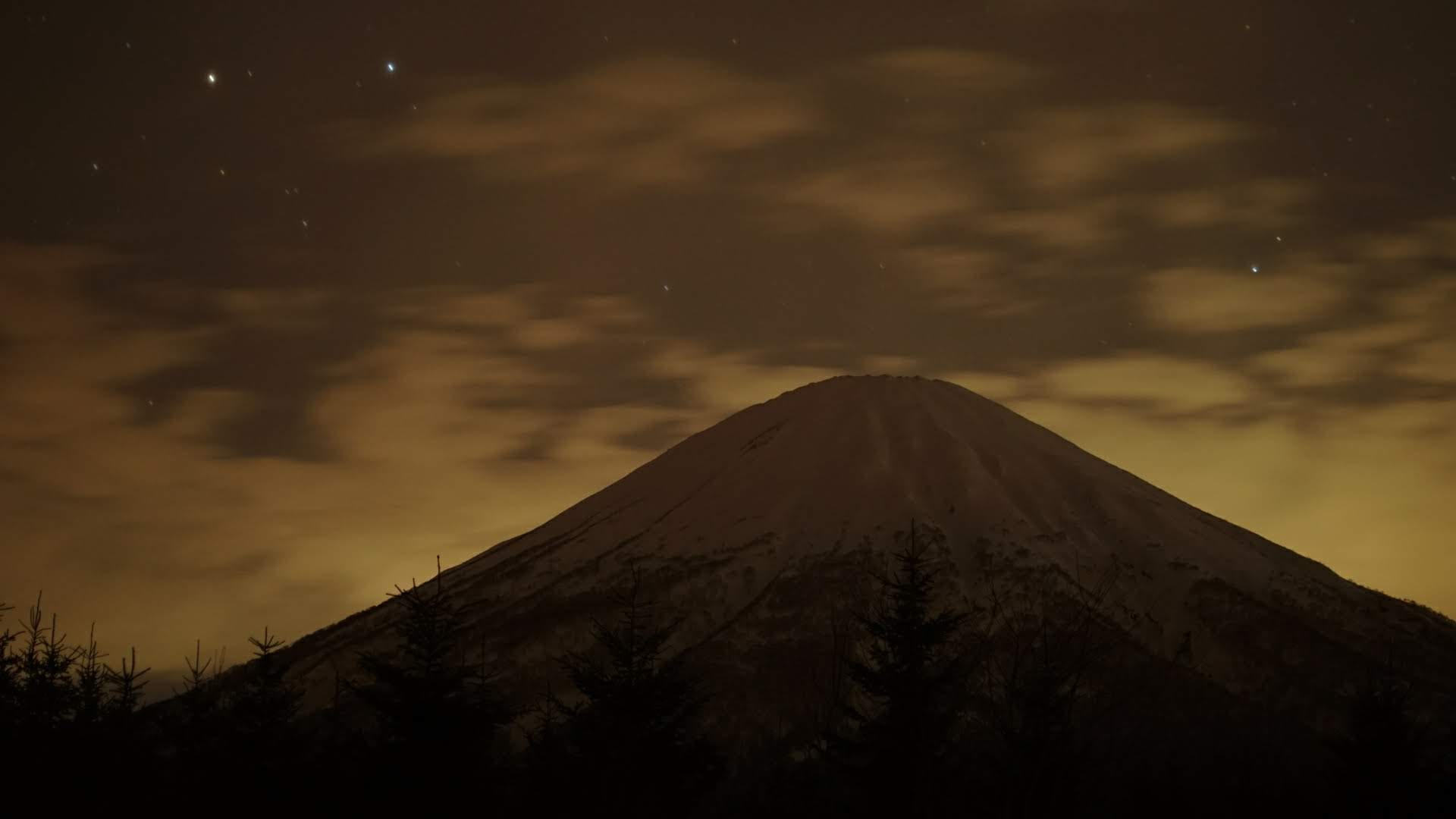 The same mountain peak at night under a field of stars